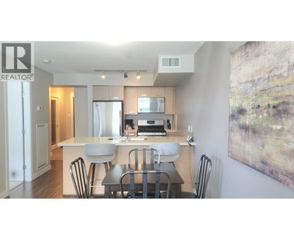 A modern kitchen with a dining table and chairs.