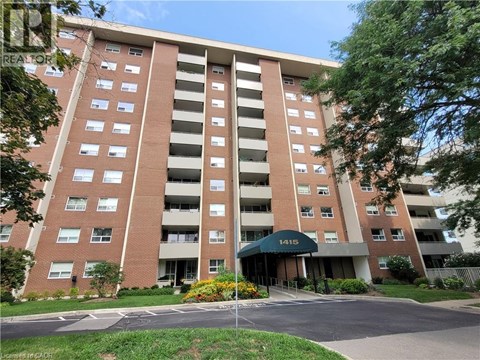 A tall apartment building with the number 1415 on it.