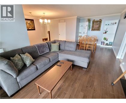 A living room with a grey couch and a wooden coffee table.