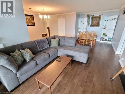 A living room with a grey couch and a wooden coffee table.
