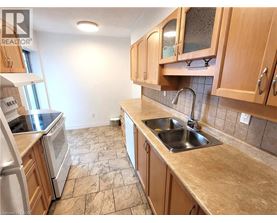 A kitchen with wooden cabinets and a tiled floor.