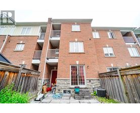 A red brick apartment building with a balcony on the second floor.