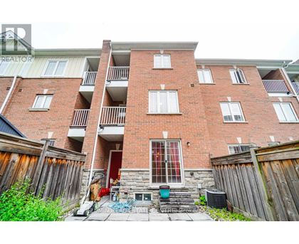 A red brick apartment building with a balcony on the second floor.