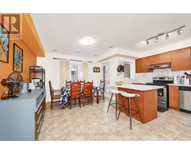 A kitchen with a dining table and chairs.