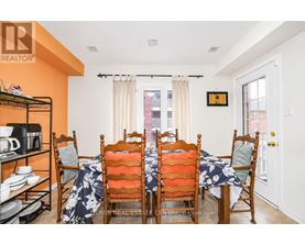 A dining room with a table set for six.