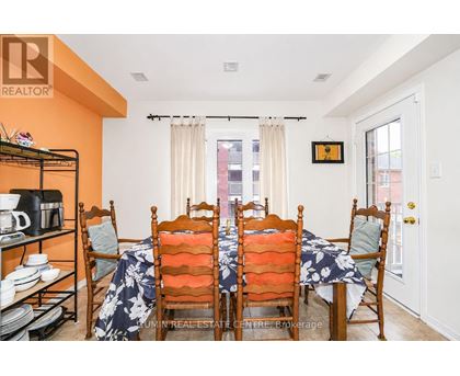 A dining room with a table set for six.