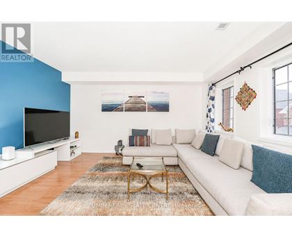 A living room with a white couch and a television.