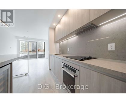 A modern kitchen with a stainless steel oven and a marble countertop.