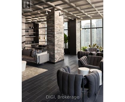 A modern living room with a stone pillar and grey furniture.