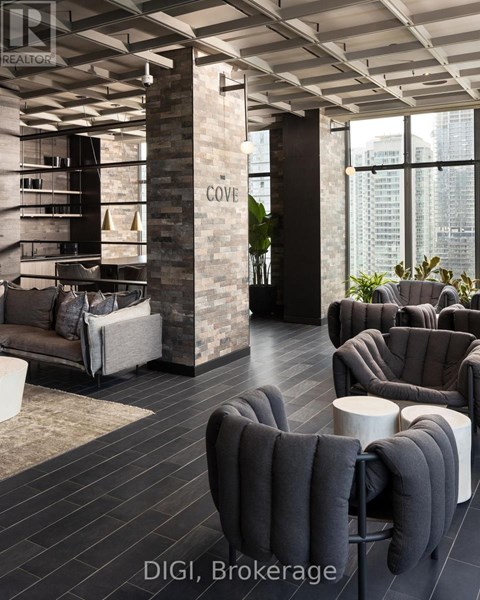 A modern living room with a stone pillar and grey furniture.