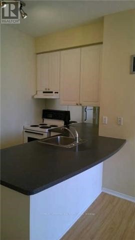 A kitchen with a black counter top and white cabinets.