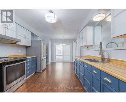 A kitchen with blue cabinets and a wooden counter top.