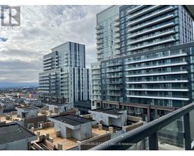 A cityscape with modern buildings and a cloudy sky.