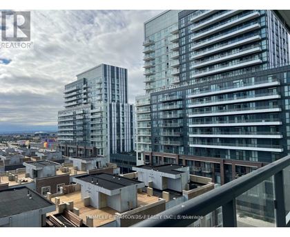 A cityscape with modern buildings and a cloudy sky.