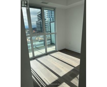 A room with a view of a cityscape through large windows.