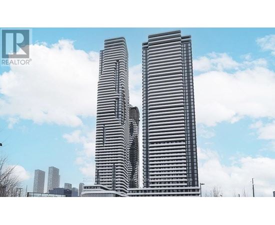 Two tall buildings with a blue sky and clouds in the background.