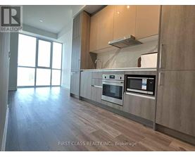 A modern kitchen with wooden cabinets and stainless steel appliances.