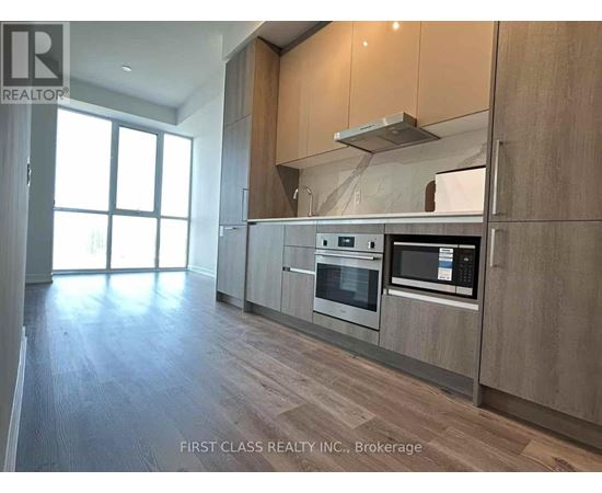 A modern kitchen with wooden cabinets and stainless steel appliances.