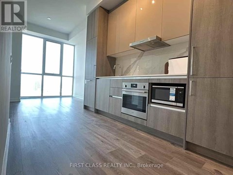 A modern kitchen with wooden cabinets and stainless steel appliances.