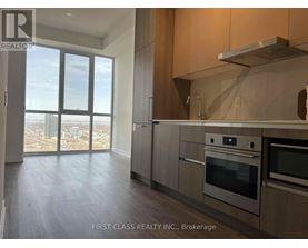 A kitchen with a stainless steel range hood above the stove.