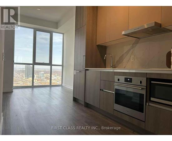 A kitchen with a stainless steel range hood above the stove.