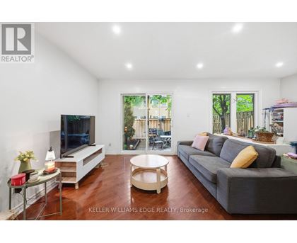 A living room with a grey couch and a television.