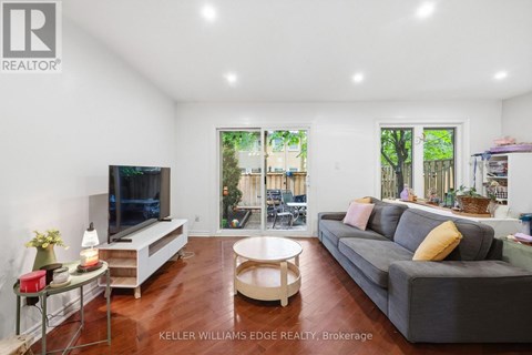 A living room with a grey couch and a television.