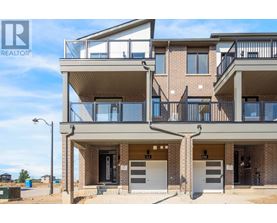A modern apartment building with a balcony on the second floor.
