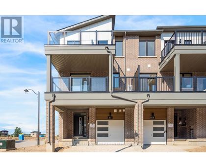 A modern apartment building with a balcony on the second floor.
