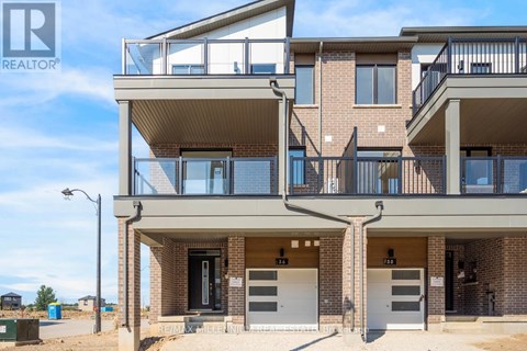 A modern apartment building with a balcony on the second floor.