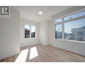 A sunny room with a window overlooking a cityscape.