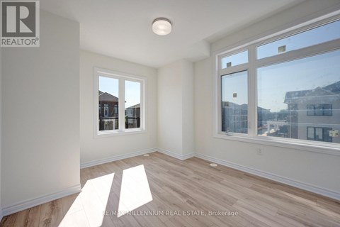 A sunny room with a window overlooking a cityscape.