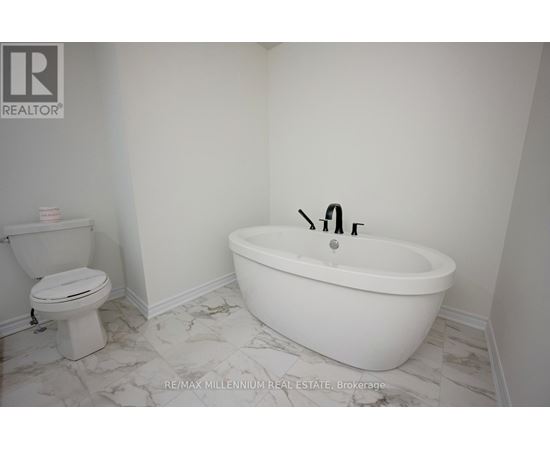 A white bathroom with a toilet and a bathtub.