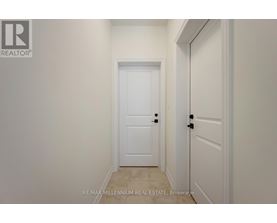 A white door is in a hallway with a RE/MAX real estate logo.
