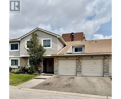 A two-story house with a garage is for sale.