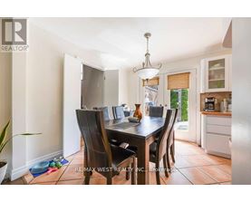 A dining room with a table set for four.