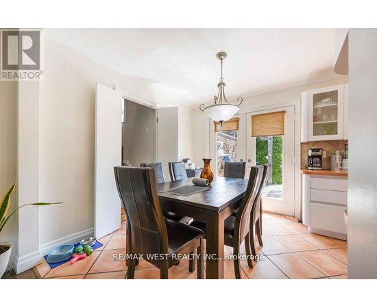 A dining room with a table set for four.