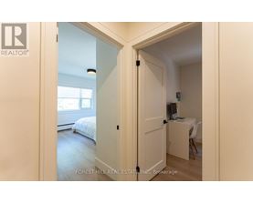 A bedroom with a bed, desk, and chair is shown in a real estate listing.