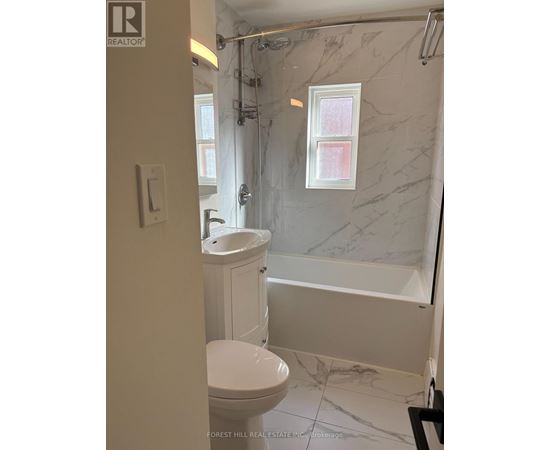 A bedroom with a bed, desk, and chair is shown in a real estate listing.
