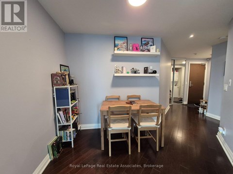 A dining room with a wooden table and chairs.