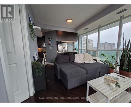 A living room with a grey couch and a coffee table.