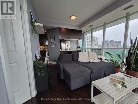 A living room with a grey couch and a coffee table.