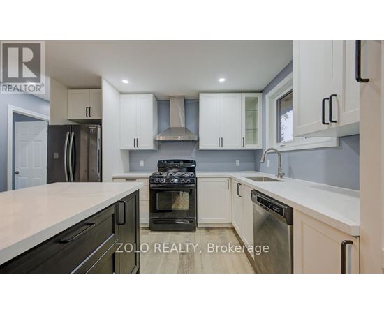 A kitchen with white cabinets and a black stove top oven.