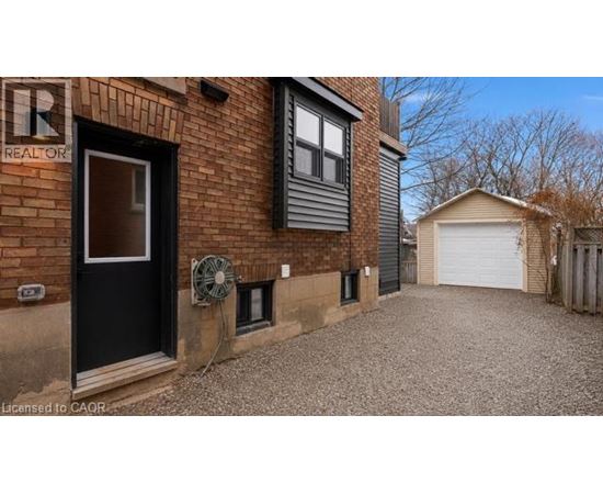 A brick house with a sign that says REALTOR.