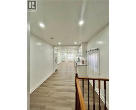 A long hallway with a railing on the right side.