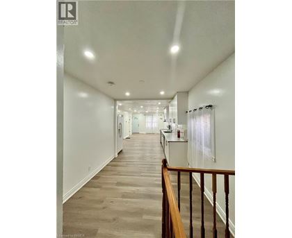 A long hallway with a railing on the right side.