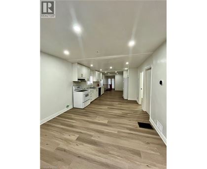A long hallway with a kitchen area at the end.