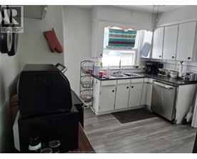 A kitchen with a black grill on the counter.