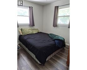 A bedroom with a bed, pillow, and blanket.
