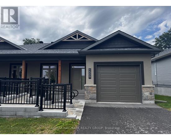 A house with a grey garage door and a black gate.